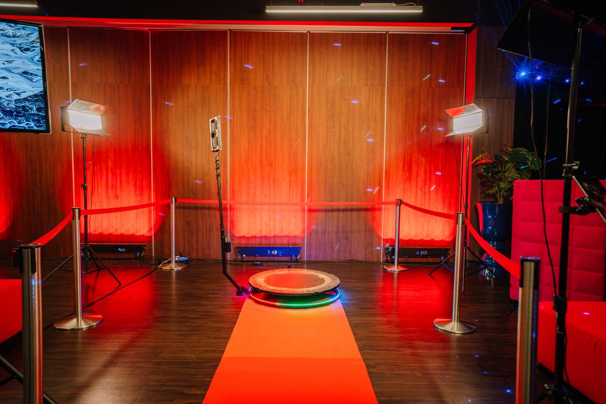 360 spinner photo booth setup with red carpet and LED lighting at a Fort Worth event