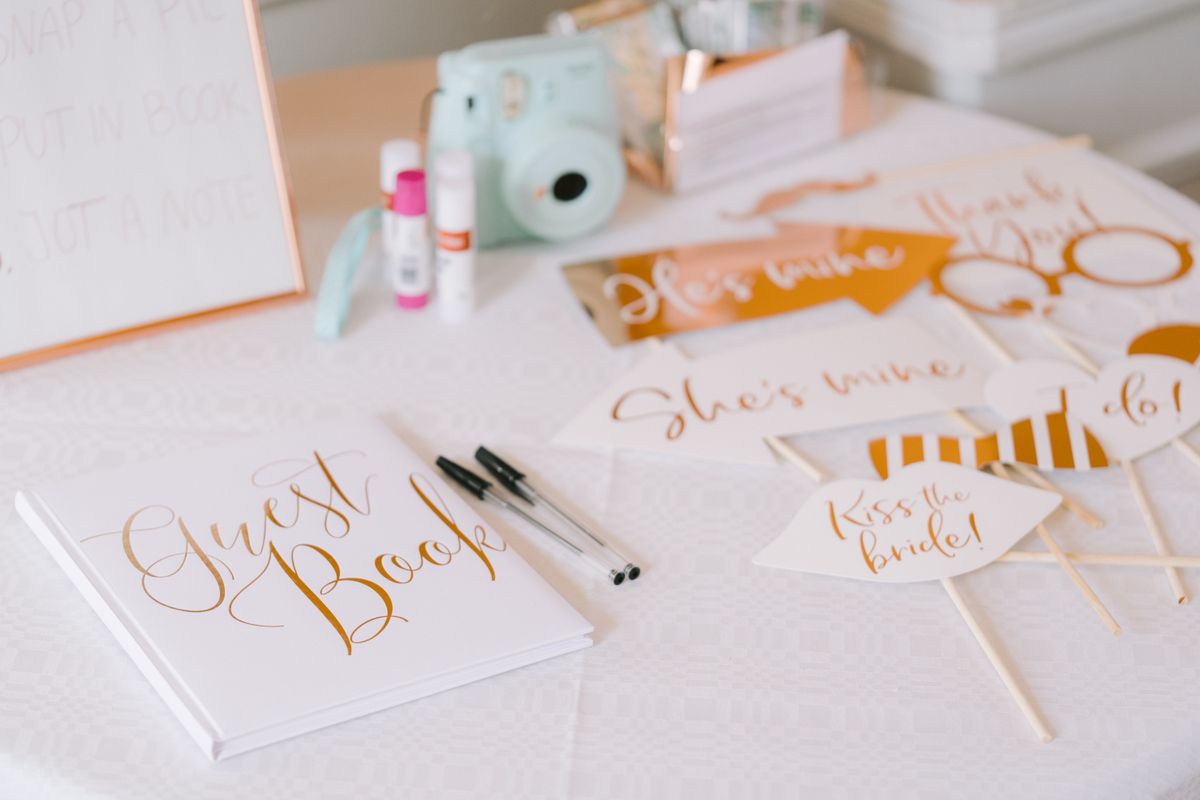 Wedding photo booth guest book with calligraphy, Polaroid camera, and props