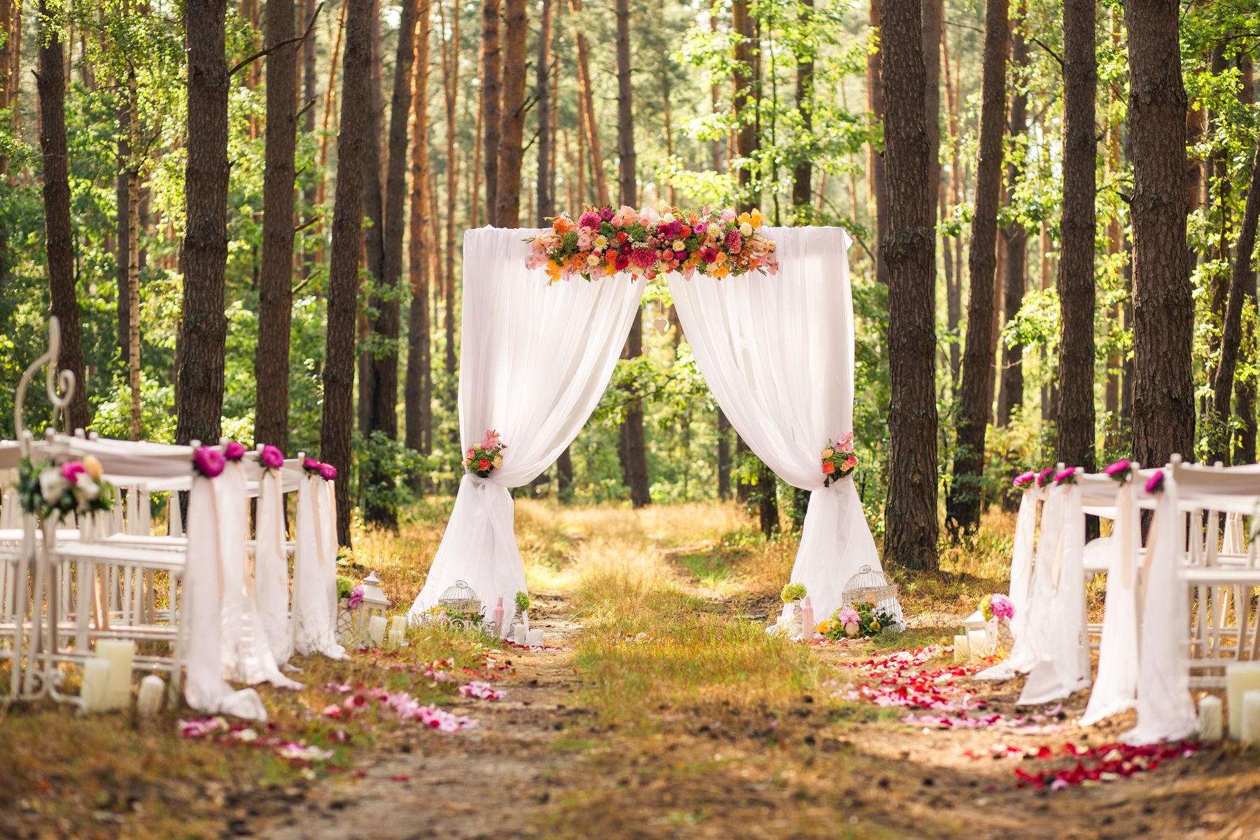 Fort Worth wedding photo booth rental at an elegant outdoor wedding venue with floral arch